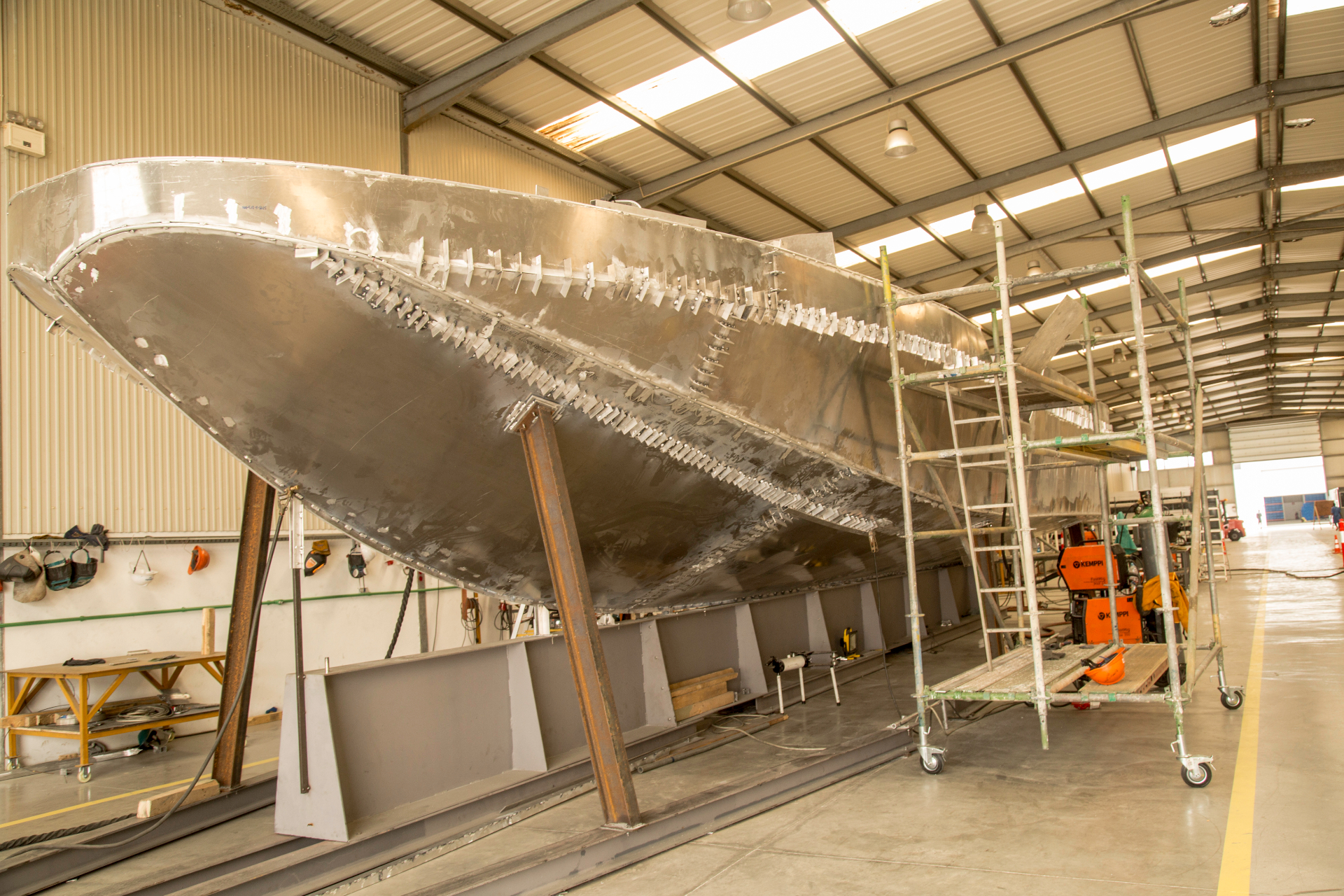 Large aluminium vessel hull under construction at Kianda