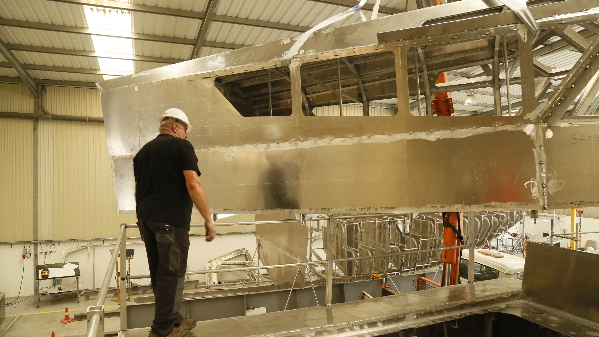 Kianda supervisor inspecting an aluminium hull structure